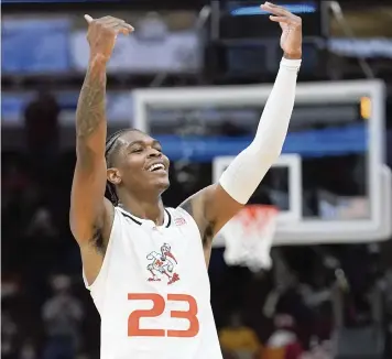  ?? NAM Y. HUH AP ?? The Hurricanes’ Kameron McGusty raises his arms in triumph after scoring a team-leading 27 points against Iowa State on Friday night to lead Miami to the Midwest Regional final against Kansas with a Final Four berth on the line.