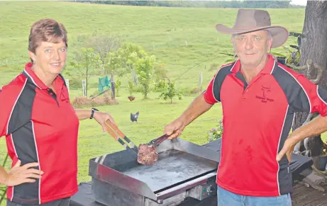  ?? Picture: JOHN ANDERSEN ?? HAPPY CHANCE: Leanne and Geoff Haines cook a grass- fed wagyu steak on their Malanda veranda.