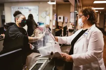  ?? ?? Critical care nurse manager Kim Diaz (right) high-fives nurse assistant Mallay Crownover at Adventist Health Sonora. The hospital had to expand its ICU during the pandemic.