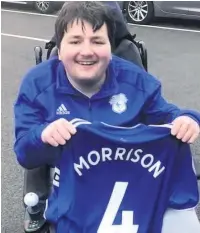  ??  ?? Liam Davies, from Pencoed, with a Cardiff City shirt given to him by player Sean Morrison