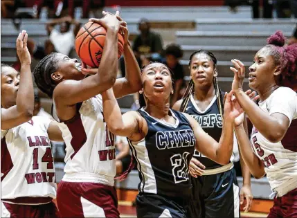  ?? RICHARD GRAULICH / THE PALM BEACH POST ?? Lake Worth’s Recilia Nonnombre (left) and Santaluces’ Brittney Howell compete for a rebound Thursday. Nonnombre led the Trojans with 15 points. “She makes everyone around her better,” Trojans coach Markus Emerson said of the junior guard.