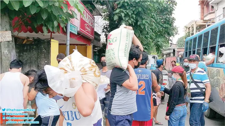  ?? ALDO NELBERT BANAYNAL ?? Residents of Barangay Mabolo in Cebu City receive sacks of rice that the city government distribute­d to the barangays yesterday. The rice forms part of the assistance that Mayor Edgardo Labella’s administra­tion delivers to the barangays amid the coronaviru­s crisis.