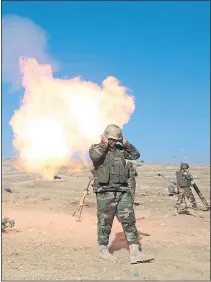  ??  ?? Kurdish Peshmerga troops attack IS positions in the Iraqi city of Mosul and, right, smoke rises after a Coalition strike yesterday