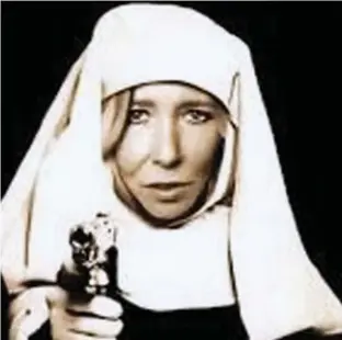  ??  ?? Terror recruiter: Sally Jones posing as a nun in an image she posted online Past life: On stage with punk rock band Krunch