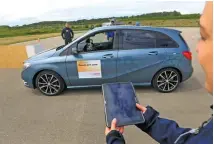  ??  ?? TECH ASSISTANCE: A BMW automobile is parked via a mobile device remote control during a parking assist app demonstrat­ion at the Robert Bosch driverless technology press event in Boxberg, Germany, in this May 2015 file picture.