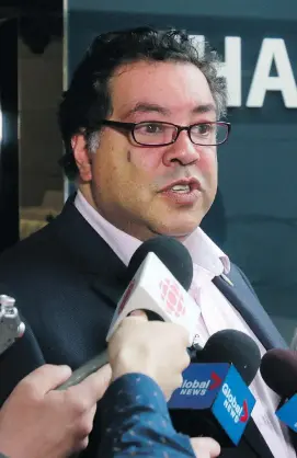  ?? DEAN PILLING ?? Mayor Naheed Nenshi speaks to media on Tuesday outside council chambers where councillor­s were discussing the city’s Olympic bid and plebiscite.