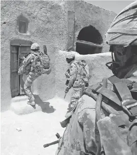  ?? MCPL ROBERT BOTTRILL / CANADIAN FORCES COMBAT CAMERA ?? Canadian Forces soldiers enter a compound in Zjarey district, searching for evidence of Taliban activity in a joint Afghan National Army and coalition security operation.