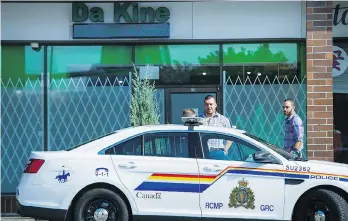  ?? RICHARD LAM/ FILE ?? A Surrey RCMP car is parked outside Da Kine marijuana shop while awaiting a court warrant to raid the business, in 2016. Today Surrey is at work developing rules about where and how pot shops will be allowed.