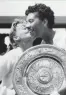  ??  ?? Althea Gibson, right, gets a congratula­tory kiss from her opponent, Darlene Hard, after winning the women’s singles title at Wimbledon on July 6, 1957. AP