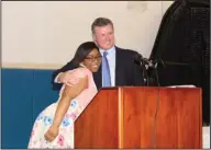  ??  ?? Thanks: Bre'Ona Douglas hugs Joe Hickman as she accepts her medallion.