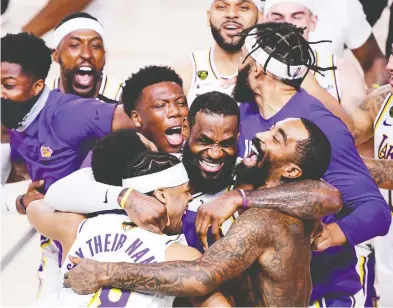  ?? DOUGLAS P. DEFELICE / GETTY IMAGES ?? LeBron James of the Los Angeles Lakers celebrates with teammates after winning the 2020 NBA Championsh­ip in Game Six of the 2020 NBA Finals at AdventHeal­th Arena at the ESPN Wide World Of Sports Complex on Sunday.