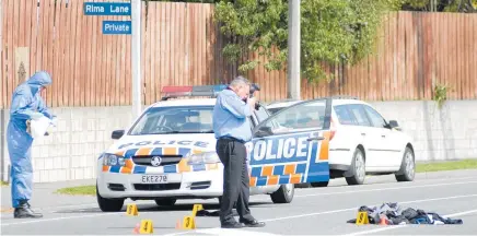  ?? Photos /Geoff Sloan ?? A police photograph­er records evidence after the 2012 shooting in Hoon Hay Rd, Christchur­ch.