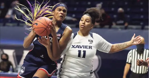  ?? Gary Landers / Associated Press ?? UConn forward Aaliyah Edwards, left, fights for a rebound against Xavier last season.