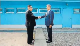  ?? AFP ?? North Korea's leader Kim Jong Un (left) shakes hands with South Korea's President Moon Jaein at the Military Demarcatio­n Line that divides their countries on April 27, 2018.