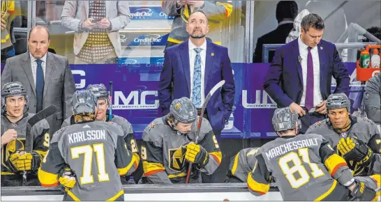  ?? L.E. Baskow Las Vegas Review-journal @Left_eye_images ?? Knights head coach Pete Deboer, center, looks up at the scoreboard at T-mobile Arena as his team prepares to start the third period against the Capitals with a 3-0 lead.