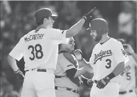  ?? Gina Ferazzi Los Angeles Times ?? CHRIS TAYLOR (3) is greeted by pitcher Brandon McCarthy in front of Chicago Cubs catcher Miguel Montero after hitting a home run in May.