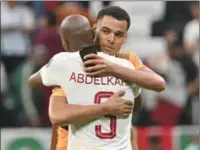  ?? (AFP) ?? Netherland­s’ forward Cody Gakpo hugs Qatar’s defender Karim Abdel Hassan after their match at the Al Bayt Stadium on Tuesday.