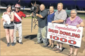  ?? RED SHORES/SPECIAL TO THE GUARDIAN ?? David Dowling celebrates his 1,000th win as a driver in the Red Shores at Summerside Raceway winner’s circle with Flash In The Pang Monday evening. From left are Brittney Watts holding baby Harrison Dowling, David Dowling, Pat Murphy, Barb Murphy, Earl...