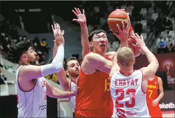  ?? XINHUA ?? Team China’s Zhou Qi is swarmed by Lebanon players as he tries to get a shot away during Wednesday’s FIBA Asia Cup quarterfin­al match in Jakarta. Zhou scored 22 points and grabbed 21 rebounds but China lost 69-72 as Lebanon progressed to the last four.