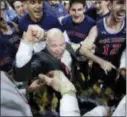  ?? JOHN LOCHER — ASSOCIATED PRESS FILE ?? St. Mary’s head coach Randy Bennett celebrates with his team after defeating Gonzaga, 60-47, in the West Coast Conference tournament in Las Vegas.