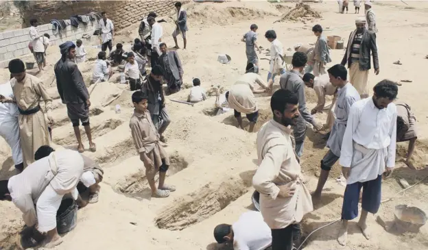  ?? PICTURE: AFP/GETTY IMAGES ?? 0 Yemenis dig graves for children killed when their bus was hit during a Saudi-led coalition air strike on the Houthi rebels’ stronghold of Saada