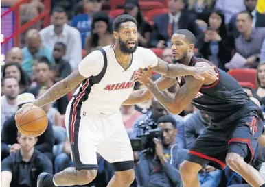  ?? WILFREDO LEE/AP ?? Heat forward James Johnson, left, drives past Houston forward Trevor Ariza during the first half Tuesday in Miami.