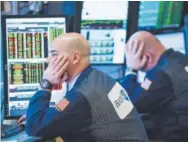  ??  ?? Traders on the floor of the New York Stock Exchange waitWednes­day to learn if the Federal Reserve would raise interest rates. It did not. Andrew Burton, Getty Images