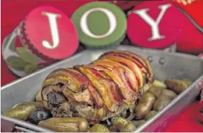  ?? DEBORAH CANNON/AMERICAN- ?? A pork roast with potatoes is a great way to celebrate any holiday.