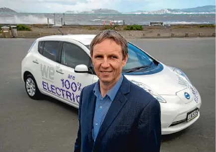  ??  ?? Wellington Electricit­y CEO Greg Skelton with one of the company’s Nissan Leafs. Photo: JOHN NICHOLSON/ FAIRFAX NZ