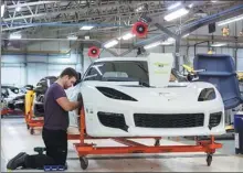  ?? BLOOMBERG ?? An employee works on a Lotus Evora sports car as it moves down the production line at the Group Lotus Plc plant in Hethel, the United Kingdom.