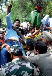  ?? — BIPLAB BANERJEE ?? BJP Yuva Morcha members protest against Himachal Pradesh chief minister Virbhadra Singh outside Congress president Sonia Gandhi’s residence in New Delhi on Sunday.