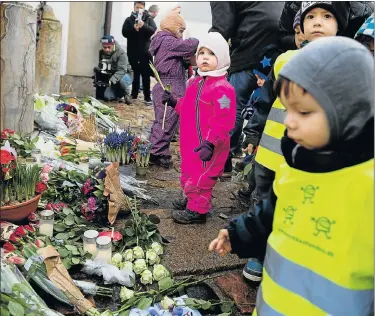  ?? Picture: AFP/ SCANPIX / LISELOTTE SABROE ?? FOND FAREWELL: Children lay flowers in front of Fredensbor­g Palace in Fredensbor­g, Denmark, in a tribute to His Royal Highness Prince Henrik