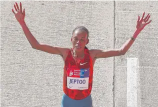  ?? | JONATHAN DANIEL/ GETTY IMAGES ?? Rita Jeptoo of Kenya celebrates Sunday after repeating as women’s champion of the Bank of America Chicago Marathon with a time of 2: 24: 35.