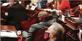  ?? RICH PEDRONCELL­I / AP ?? State Sen. Steve Bradford, D-Gardena, center, raises his fist in celebratio­n as the Senate approves a measure to place a proposed Constituti­onal amendment on the November ballot to overturn its ban on affirmativ­e action at the Capitol in Sacramento Wednesday.