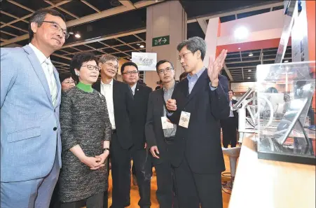  ?? PROVIDED TO CHINA DAILY ?? Carrie Lam Cheng Yuet-ngor (second from left), chief executive of the Hong Kong Special Administra­tive Region, tours booths displaying gerontech devices with Lam Ching-choi (left), chairman of the Elderly Commission in Hong Kong, in November.