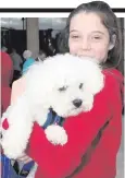  ??  ?? Katie Baxter (12) gets plenty of love from her rescue dog Harley