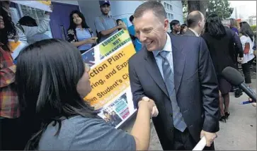  ?? Photog raphs by Bob Chamberlin
Los Angeles Times ?? L.A. SCHOOLS SUPT. JOHN DEASY greets Manual Arts High School senior Laura Aguilar, 17, after announceme­nt of sweeping changes in discipline policies. “We are about graduation, not incarcerat­ion,” he says.