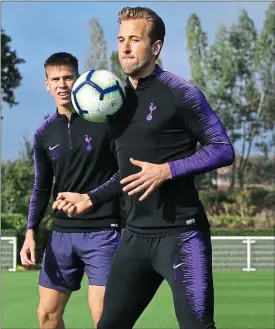  ??  ?? Action man: Harry Kane back in training with Spurs yesterday, watched by Juan Foyth