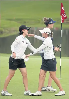 ??  ?? Lee Jeong-Eun6, left, and Sarah Smith celebrate at the end of the first round.