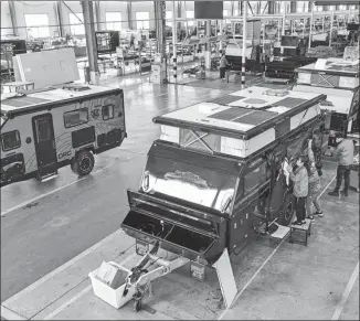  ?? LI XINJUN / FOR CHINA DAILY ?? Employees work at a recreation­al vehicle assembly line in Rongcheng, Shandong province, in November.