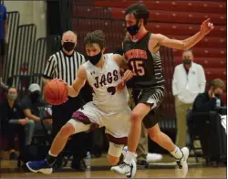  ?? OWEN MCCUE - MEDIANEWS GROUP ?? Garnet Valley’s Carl Schaller, left, is bumped by Perkiomen Valley’s Dom Miceli as Schaller drives to the basket Friday. Schaller scored 26 points to lead the Jaguars to a 63-38win over Perk Valley in the District 1 Class 6A quarterfin­als.