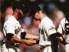  ?? D. Ross Cameron / Associated Press ?? San Francisco manager Gabe Kapler (left) takes the ball from starting pitcher Anthony DeSclafani in the seventh inning.