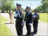  ?? EVAN BRANDT — DIGITAL FIRST MEDIA ?? From left, Greg Seanor and Montgomery County Sheriff’s Deputies Adam Seanor, Mike Wambold and Kasey Sapp, begin the flag raising ceremony Thursday at Edgewood Cemetery in Recognitio­n of Flag Day.