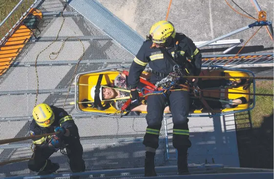  ?? Picture: STEVE HOLLAND ?? Rescue training for firefighte­rs such as this involving scaling a building can be a pretty nerve-racking experience.