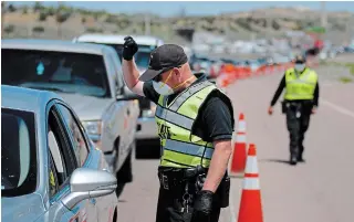  ?? MORGAN LEE THE ASSOCIATED PRESS FILE PHOTO ?? Police in Gallup, N.M., have set up roadblocks to discourage non-emergency shopping after an outbreak on the Navajo Nation prompted a 10-day lockdown of the city.