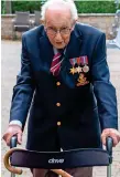  ??  ?? AGE NO BAR: Tom Moore walking in his garden in Marston Moretaine, north of London to raise money. — Reuters