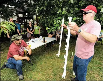  ?? NWA Democrat-Gazette/ANDY SHUPE ?? Ken Coffey talks with participan­ts in the Armed to Farm program about fencing Wednesday at his sheep and goat farm near Prairie Grove.