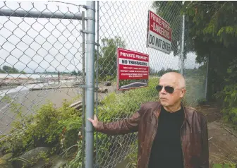  ?? JASON PAYNE ?? Barrie Philp stops at a fence on Thursday where the Fraser River Trail ends and the Marine Drive Golf Club begins. He says his great-grandfathe­r, who provided land for the club, would have backed open trail access.