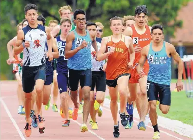  ?? JIM THOMPSON/JOURNAL ?? Volcano Vista’s Jericho Cleveland, No. 1 at the far left, runs on the outside of a tight pack early in the boys 1,600 Saturday at the Richard A. Harper Memorial meet at Albuquerqu­e Academy. Cleveland went on to win the race.