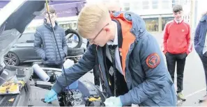  ??  ?? Work Alexander Stewart gets to grip with the engine